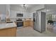 Modern kitchen with stainless steel appliances and light wood cabinets at 2421 Healy Dr, Orlando, FL 32818