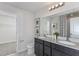 Double vanity bathroom with dark cabinets and a walk-in shower at 2440 Belle Haven Way, Davenport, FL 33896