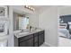 Double vanity bathroom with dark cabinets and a view into the bedroom at 2440 Belle Haven Way, Davenport, FL 33896