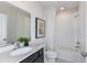 Clean bathroom with a white tub and dark vanity at 2440 Belle Haven Way, Davenport, FL 33896