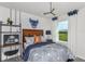 Stylish bedroom with a wood headboard, geometric bedding, and a desk area at 2440 Belle Haven Way, Davenport, FL 33896