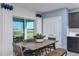 Dining area with wooden table, woven chairs, and view to backyard at 2440 Belle Haven Way, Davenport, FL 33896