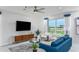 Bright living room featuring a comfy sofa and large TV at 2440 Belle Haven Way, Davenport, FL 33896