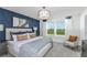 Main bedroom with a king-size bed and an accent wall at 2440 Belle Haven Way, Davenport, FL 33896