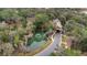 Aerial view of community entrance with pond and lush landscaping at 25500 Hawks Run Ln, Sorrento, FL 32776