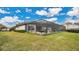 Spacious backyard with a large grassy area and screened pool area at 25500 Hawks Run Ln, Sorrento, FL 32776