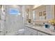 Bathroom with marble shower, granite countertop, and large mirror at 25500 Hawks Run Ln, Sorrento, FL 32776