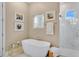 Relaxing bathroom with soaking tub, walk-in shower, and neutral color palette at 25500 Hawks Run Ln, Sorrento, FL 32776