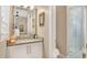 Stylish bathroom with granite vanity, glass-enclosed shower, and neutral tones at 25500 Hawks Run Ln, Sorrento, FL 32776