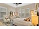 Bright bedroom with a king-size bed, chair, and window shutters at 25500 Hawks Run Ln, Sorrento, FL 32776