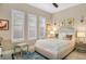 Bedroom with a queen-size bed, ottoman, and window shutters at 25500 Hawks Run Ln, Sorrento, FL 32776