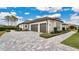 Three-car garage with paver driveway and walkway at 25500 Hawks Run Ln, Sorrento, FL 32776