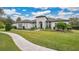 Curved walkway leads to a beautiful home with landscaping at 25500 Hawks Run Ln, Sorrento, FL 32776