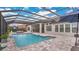 Inviting pool area with covered patio, outdoor kitchen, and ample seating at 25500 Hawks Run Ln, Sorrento, FL 32776