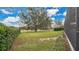 Landscaped side yard with privacy hedge and golf course views at 25500 Hawks Run Ln, Sorrento, FL 32776