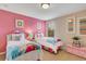 Twin bedroom with Frozen bedding and pink walls at 2616 Santosh Cv, Kissimmee, FL 34746