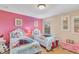 Twin bedroom with Frozen bedding and pink walls at 2616 Santosh Cv, Kissimmee, FL 34746