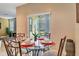 Bright breakfast nook featuring a glass table and four chairs, with access to backyard at 2616 Santosh Cv, Kissimmee, FL 34746