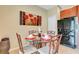 Small breakfast nook with round glass table and four chairs at 2616 Santosh Cv, Kissimmee, FL 34746