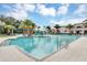 Resort-style pool with plenty of lounge chairs and palm trees at 2616 Santosh Cv, Kissimmee, FL 34746