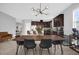 Open concept dining area with a live edge table and modern chandelier at 2662 Tahoe Ter, St Cloud, FL 34771