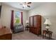 Bedroom with crib, armoire, and window with curtains at 268 Heatherbrooke Cir, Oviedo, FL 32765