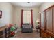 Bedroom with Pack n Play, armoire, and window with curtains at 268 Heatherbrooke Cir, Oviedo, FL 32765