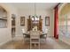 Formal dining room with a round table, wood hutch, and large windows at 268 Heatherbrooke Cir, Oviedo, FL 32765