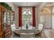 Dining room featuring a round table, large window, and red curtains at 268 Heatherbrooke Cir, Oviedo, FL 32765