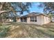 Tan house with screened porch and large backyard at 268 Heatherbrooke Cir, Oviedo, FL 32765