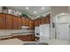 Well-equipped kitchen with ample wood cabinets, white appliances, and a large island at 268 Heatherbrooke Cir, Oviedo, FL 32765