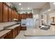 Modern kitchen with wood cabinets, white appliances, and expansive counter space at 268 Heatherbrooke Cir, Oviedo, FL 32765