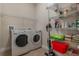 Bright laundry room with washer, dryer, and ample shelving at 268 Heatherbrooke Cir, Oviedo, FL 32765