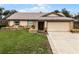 Single-story house with a two-car garage and landscaped yard at 2700 Dorado Ct, Apopka, FL 32703