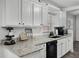 Modern kitchen featuring granite countertops and white cabinets at 2700 Dorado Ct, Apopka, FL 32703