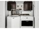 Convenient laundry room with Maytag washer and dryer, overhead cabinets, and microwave at 2700 Dorado Ct, Apopka, FL 32703