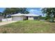 Single-story house with attached garage and a grassy yard, located near a canal at 2700 Hoover Dr, Deltona, FL 32738