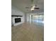 Living room with fireplace, tile floors and plenty of natural light at 2700 Hoover Dr, Deltona, FL 32738