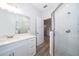 Modern bathroom with white vanity, quartz countertop, and a walk-in shower at 2712 Alamo Dr, Orlando, FL 32805