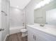 Clean bathroom with white vanity, quartz countertop, and a bathtub at 2712 Alamo Dr, Orlando, FL 32805