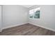 Bright bedroom with gray vinyl plank flooring and a large window at 2712 Alamo Dr, Orlando, FL 32805