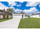 Newly constructed home with a white exterior, a two-car garage, and a well-manicured lawn at 2712 Alamo Dr, Orlando, FL 32805