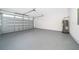 Garage with painted floor and water heater at 2712 Alamo Dr, Orlando, FL 32805