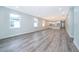 Open living room showcasing gray vinyl plank flooring and views into the kitchen at 2712 Alamo Dr, Orlando, FL 32805