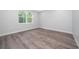 Spacious bedroom with wood-look floors and large window at 2909 S Palmetto Ave, Sanford, FL 32773