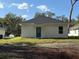 House backyard with cleared land and partial view of neighbor's home at 309 Albany Ave, Deland, FL 32724