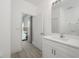 Bathroom with white vanity, mirror, and view into bedroom at 309 Albany Ave, Deland, FL 32724