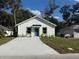 Newly constructed home with a blue door and concrete driveway at 309 Albany Ave, Deland, FL 32724