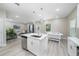 Modern kitchen with white cabinets, island, and stainless steel appliances at 309 Albany Ave, Deland, FL 32724