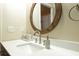 Clean bathroom with a round mirror and modern sink and faucet at 3202 Alling, Deltona, FL 32725